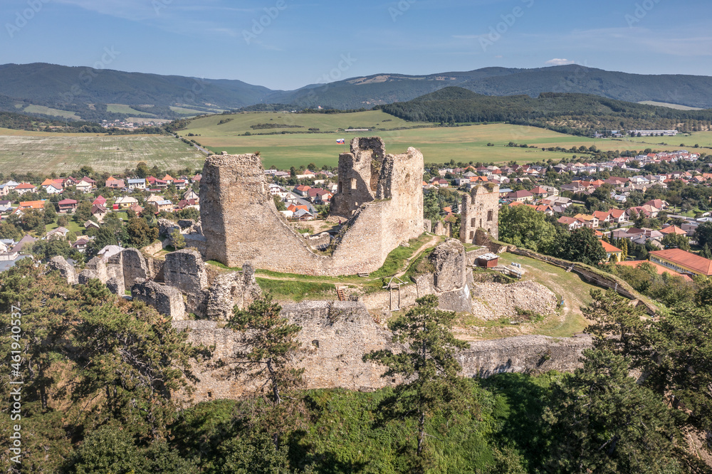 Aerial view of medieval ruined Gothic Divín castle in Southern Slovakia near Lucenec under restoration with cloudy sky background 