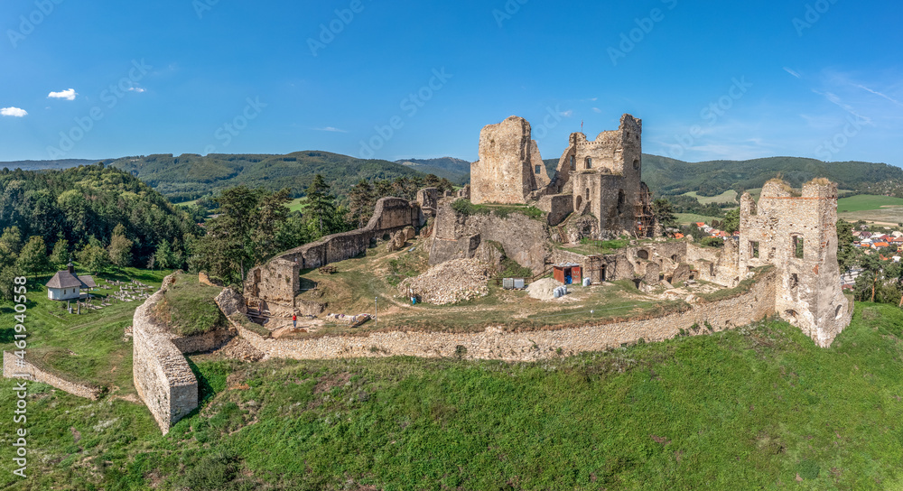 Aerial view of medieval ruined Gothic Divin castle in Slovakia with partially restored walls and towers