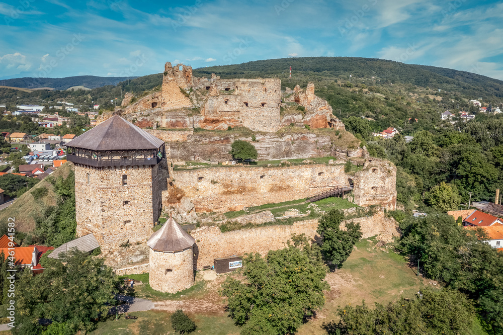 Aerial view of partially restored medieval Filakovo Fulek castle in Southern Slovakia with cannon bastion