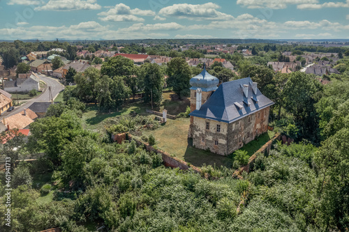 Aerial view of medieval fortified castle Erdody manor house in Janoshaza, Vas county Hungary with restored onion shape roof and blue sky, surrounded by a dry moat photo