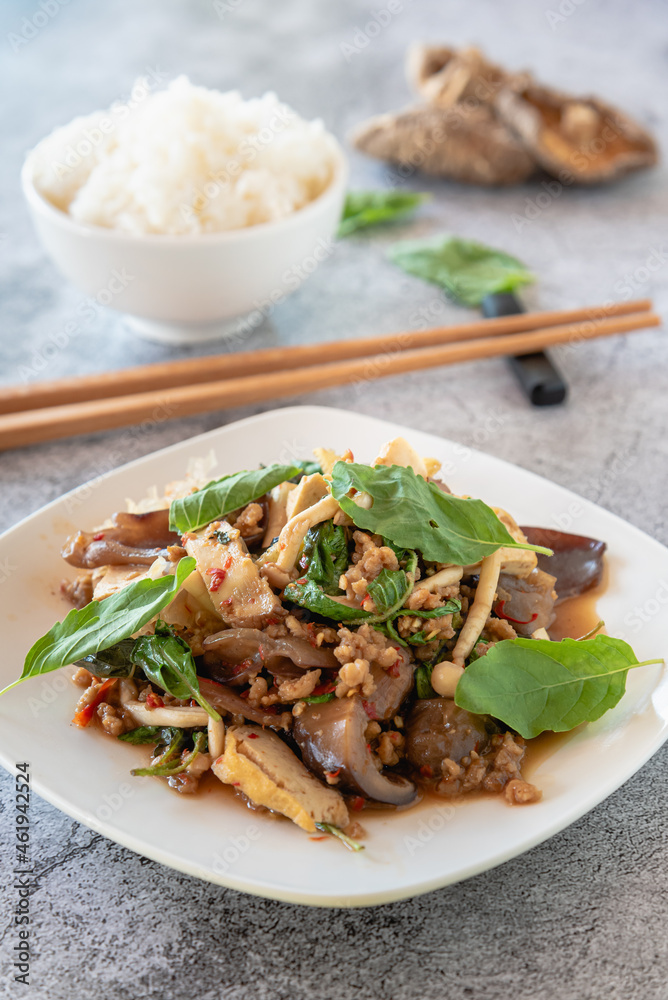 Stir fried Textured Vegetable Protein with mushroom, basil and chili on marble table for Chinese vegetarian food festival Stir fried Textured Vegetable Protein with mushroom, basil and chili on marble table for Chinese vegetarian food festival