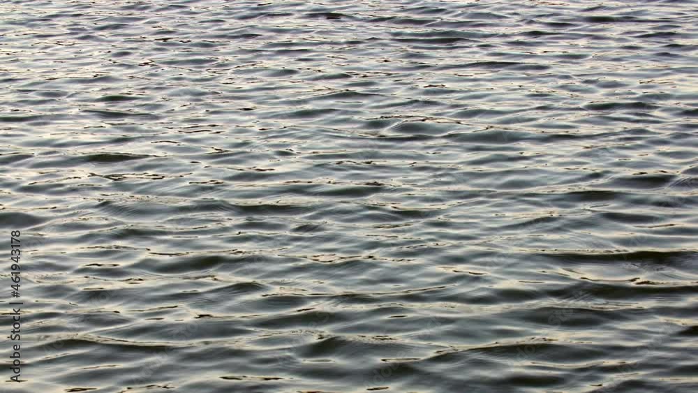 Infinite background of water waves in lake. Blue to black colors. Natural texture. Infinite background of water waves in lake. Blue to black colors. Natural texture.
