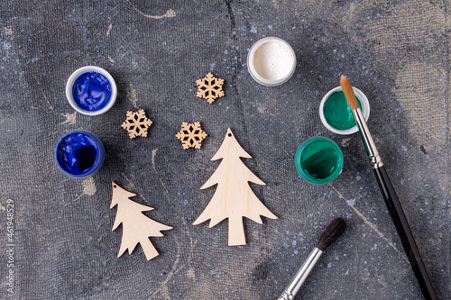 the process of painting wooden toys for the Christmas tree