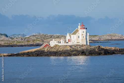 Lighthouse on an islet at the entrance of the Kristiansand harbor on the southern coast of Norway photo