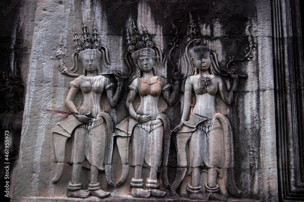 Sculpture carving figure apsaras or apsara angel deity female spirit of clouds and waters elegant and superb art of dancing in Hindu and Buddhist culture on wall of Angkor wat at Siem Reap, Cambodia