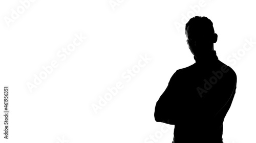 Photo of man's silhouette with arms crossed and copyspace photo