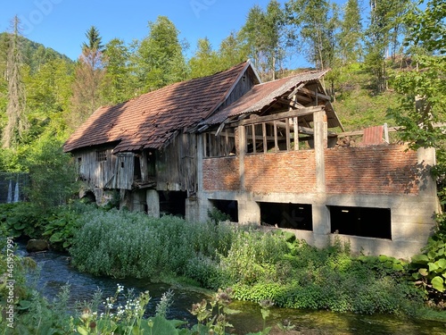 Remains of an old sawmill on the small dam of Čogrljevo Lake in the mountain hamlet of Tići - Gorski kotar, Croatia (Ostaci stare pilane na maloj brani Čogrljevog jezera u goranskom zaselku Tići) photo