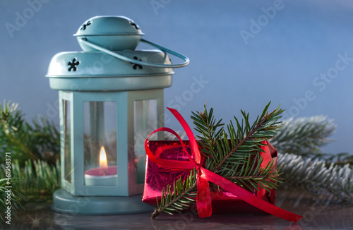 Christmas lantern on snow with fir tree and presents. New Year, Happy Holidays