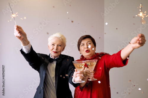 Two beautiful stylish mature senior women celebrating new year. Fun, party, style, celebration concept 