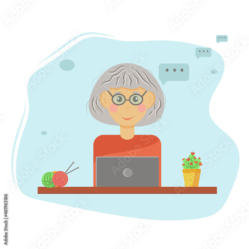 grandma is happy sitting at her laptop, chatting, looking for recipes, interesting