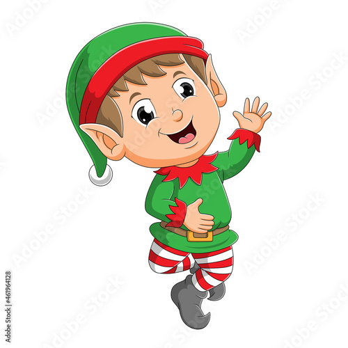 The happy elf boy with the santa hat is waving the hand
