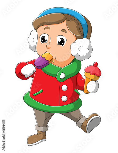 The little boy with the winter costume is eating the ice cram