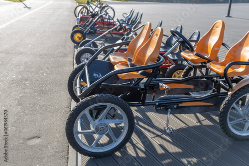 Bicycle rental in the city park. Velomobiles are parked in the park. photo