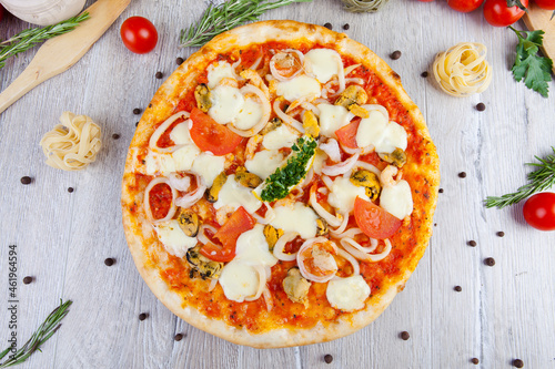 italian pizza on a wooden background with decoration around