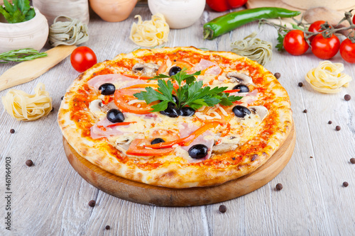 italian pizza on a wooden background with decoration around