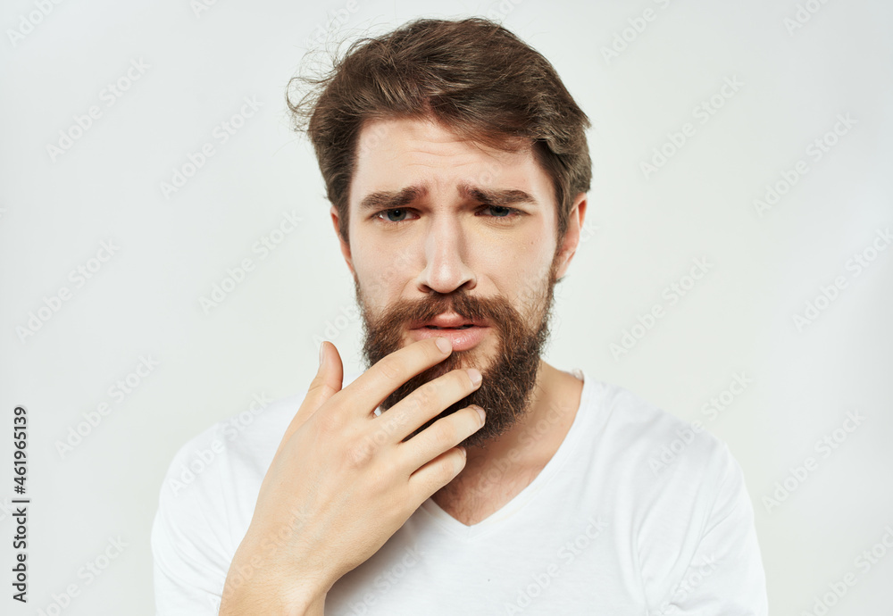 emotional man in a white t-shirt irritated facial expression Lifestyle