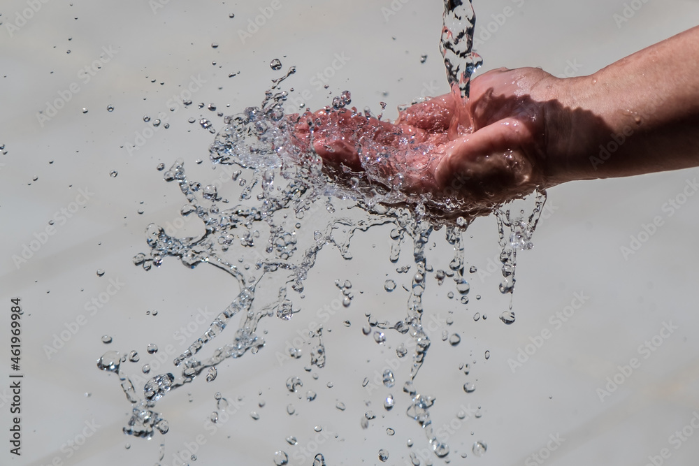 Fototapeta premium Human hand with water splashing on it