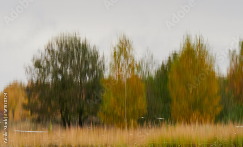 Autumn color is reflected in the still water of the lake