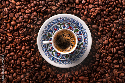 Arabic coffee cup with roasted beans photo