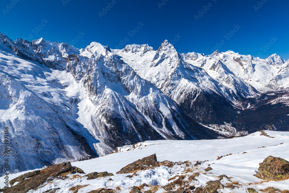 Caucasus Mountains, Panoramic view of the ski slope  on the horizon in winter day. Dombai ski resort, Western Caucasus, Karachai-Cherkess, Russia.