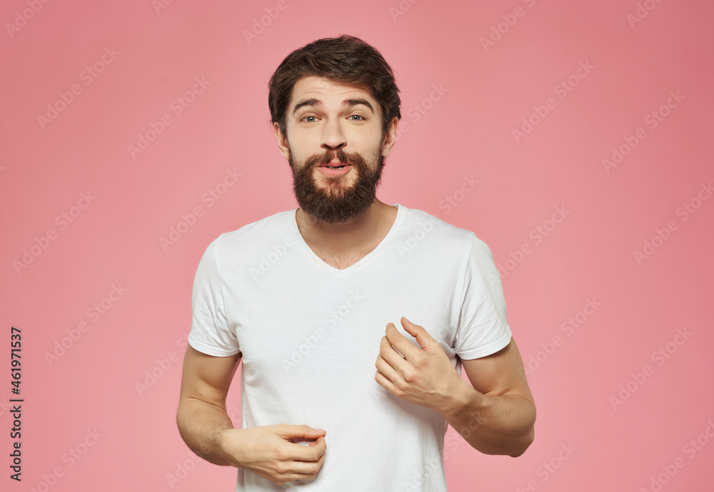 emotional man in a white t-shirt irritated facial expression pink background emotional man in a white t-shirt irritated facial expression pink background