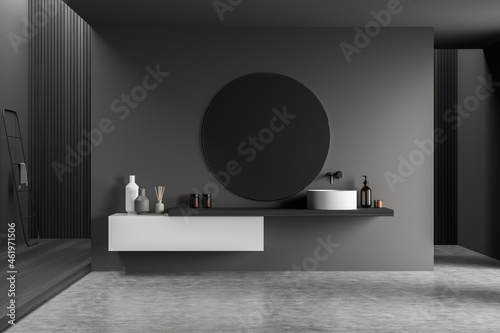 Dark bathroom interior with minimalist sink and concrete floor