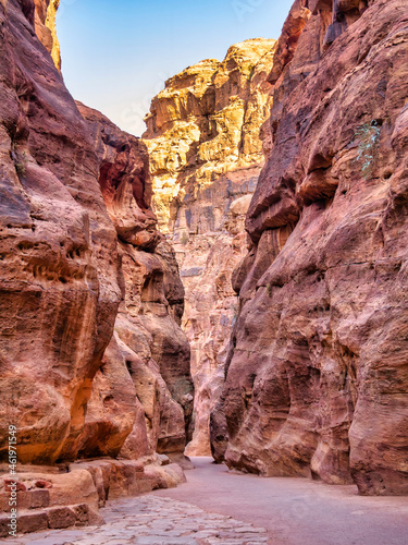 Picture with al-Siq, the natural passage through red rock walls which is main entrance to the ancient Nabatean city of Petra in southern Jordan.