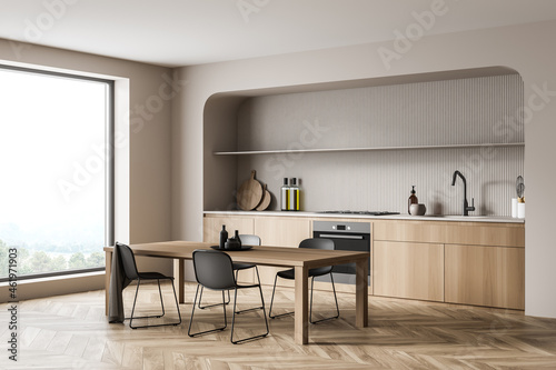 Minimalist beige wood kitchen with niche. Corner view.