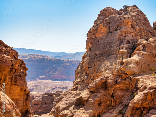 Rocky desert landscape from the ancient city of Petra, Jordan with the Royal Tombs in the background.