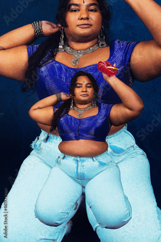 portrait of dark skinned Indian woman from Malaysia against a dark blue background photo