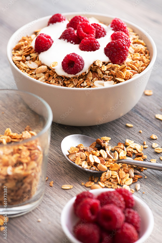 Sweet breakfast with granola, yogurt and fresh raspberries Sweet breakfast with granola, yogurt and fresh raspberries