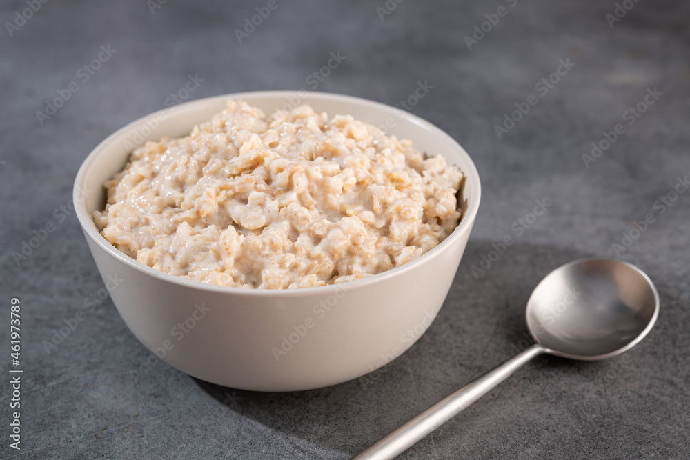 Delicious oatmeal without ingredients in a white bowl Delicious oatmeal without ingredients in a white bowl