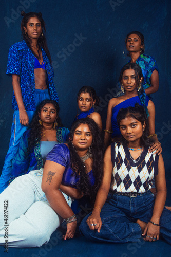 group portraits of dark skinned Indian women from Malaysia against a dark bleu background