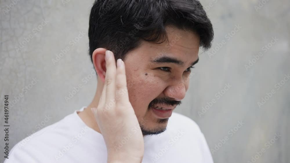 slow motion scene adult middle eastern man use hand massage on ear after feeling pain form eardrum syndrome for unhealthy lifestyle concept slow motion scene adult middle eastern man use hand massage on ear after feeling pain form eardrum syndrome for unhealthy lifestyle concept