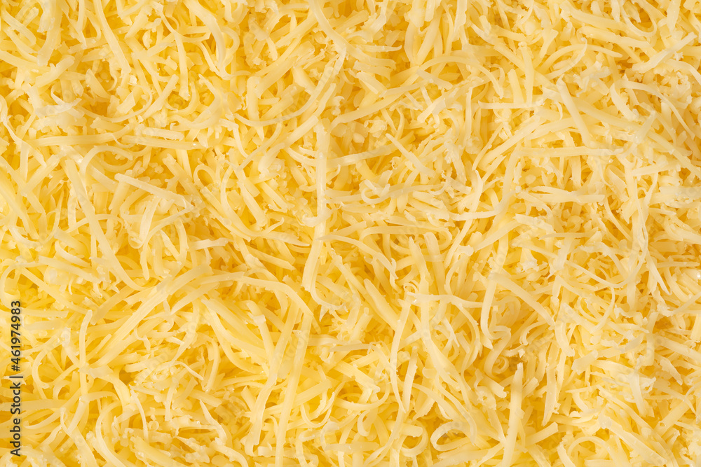 Grated cheese background texture. yellow shredded cheese. Close up top view. Grated cheese background texture. yellow shredded cheese. Close up top view.