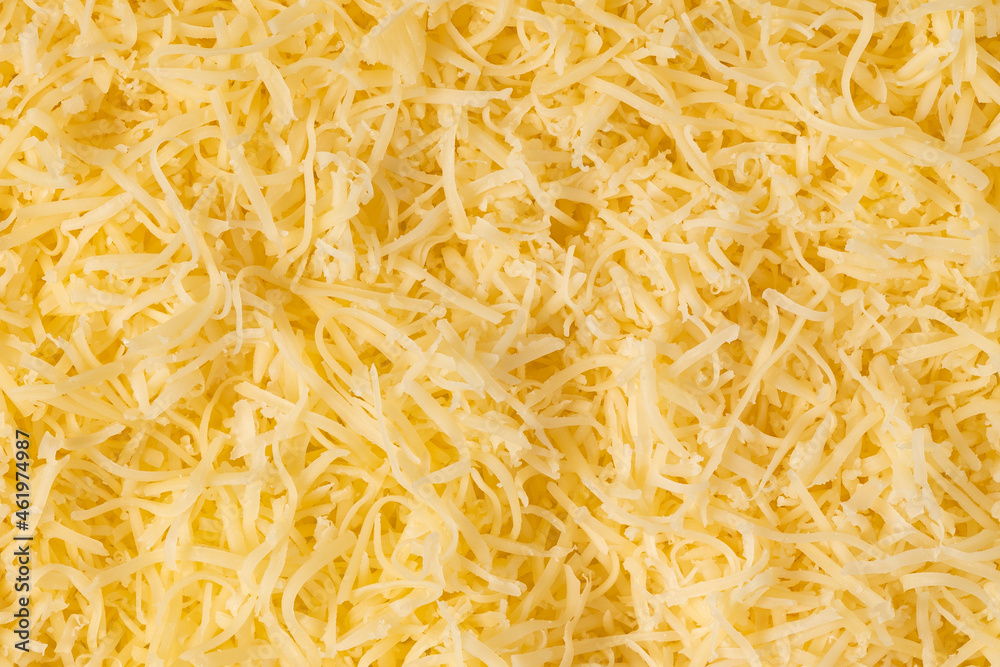 Grated cheese background texture. yellow shredded cheese. Close up top view. Grated cheese background texture. yellow shredded cheese. Close up top view.