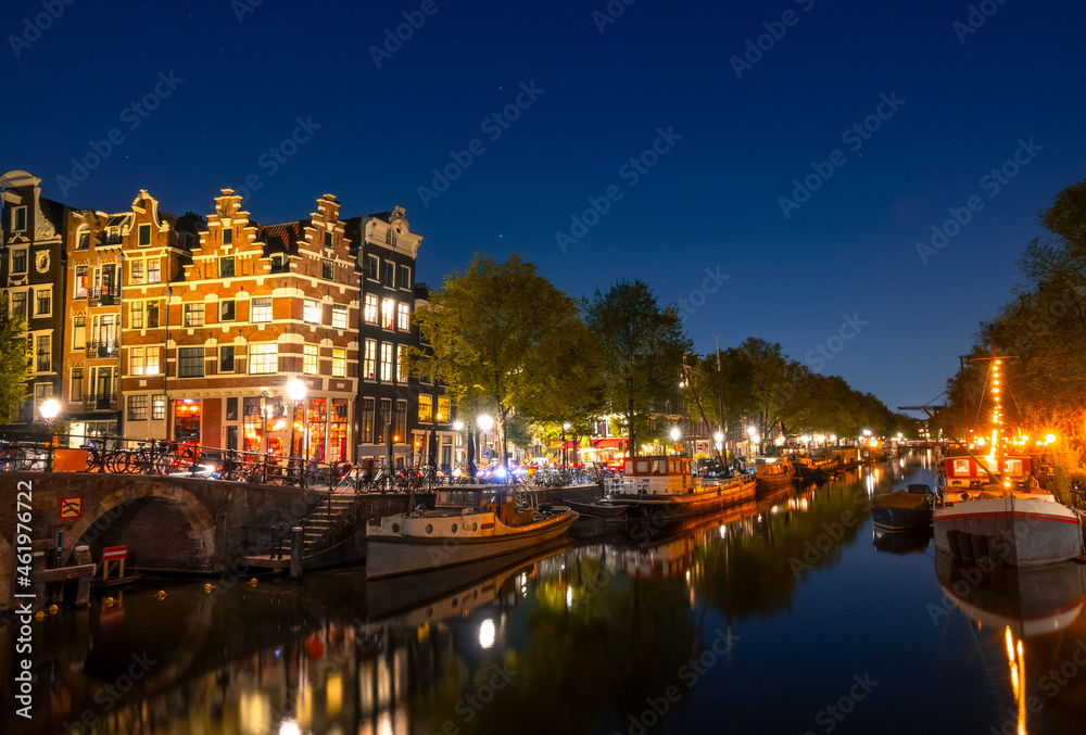 Amsterdam Canal With Boats and Traditional Houses at Night