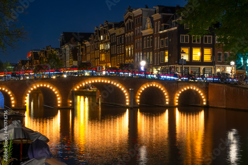 Canal in Amsterdam at Night and Illuminated Bridge