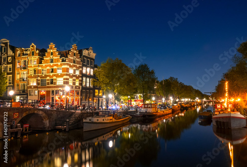 Amsterdam Canal With Boats and Traditional Houses at Night