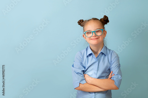 Happy girl with Down syndrome having fun and laughing in the studio photo