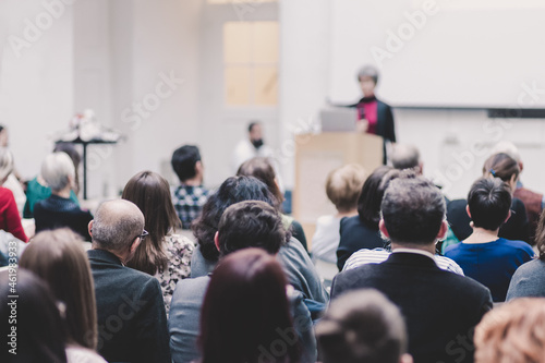 Woman giving presentation on business conference event.