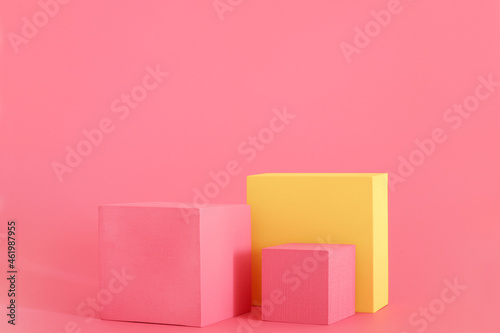 Pink and yellow podium on the pink background. Podium for product, cosmetic presentation. Creative mock up. Pedestal or platform for beauty products. © Creative_Bird