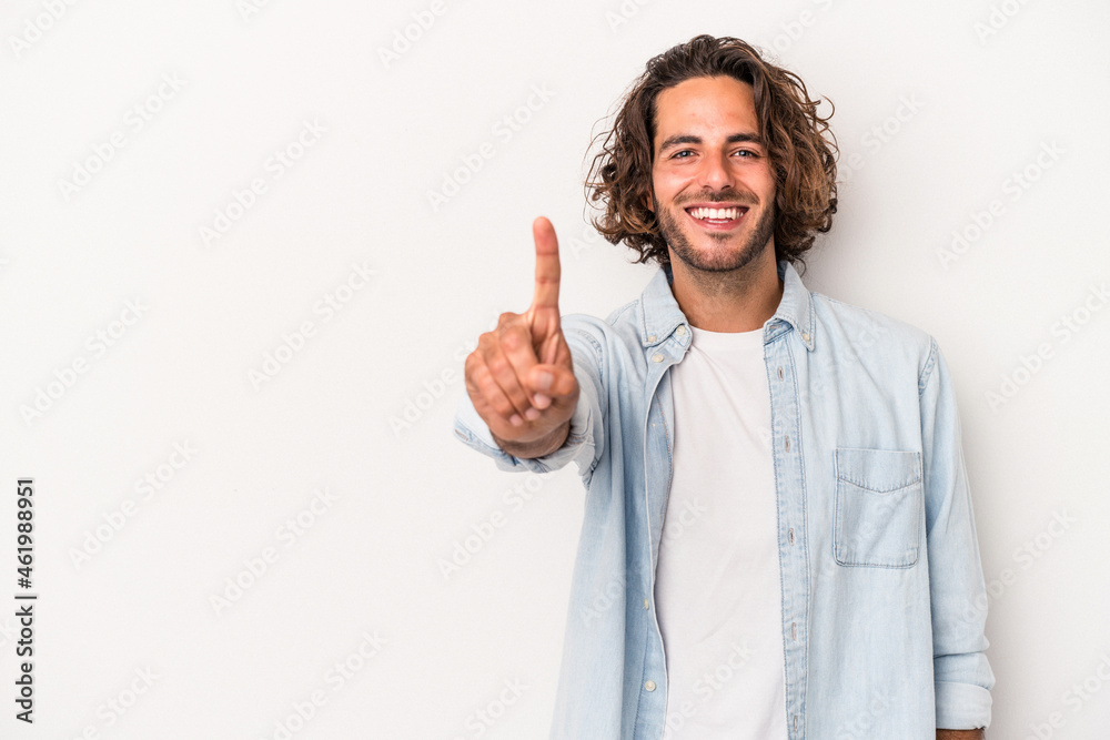 Young caucasian man isolated on white background showing number one with finger. Young caucasian man isolated on white background showing number one with finger.