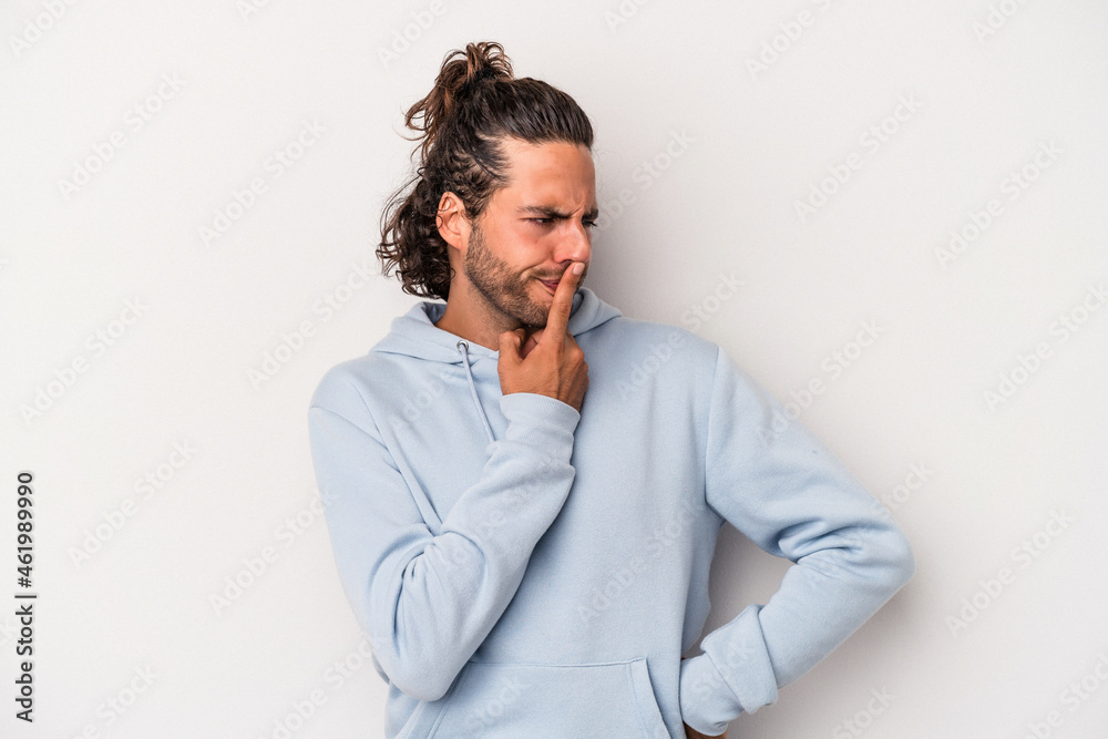 Young caucasian man isolated on gray background keeping a secret or asking for silence. Young caucasian man isolated on gray background keeping a secret or asking for silence.