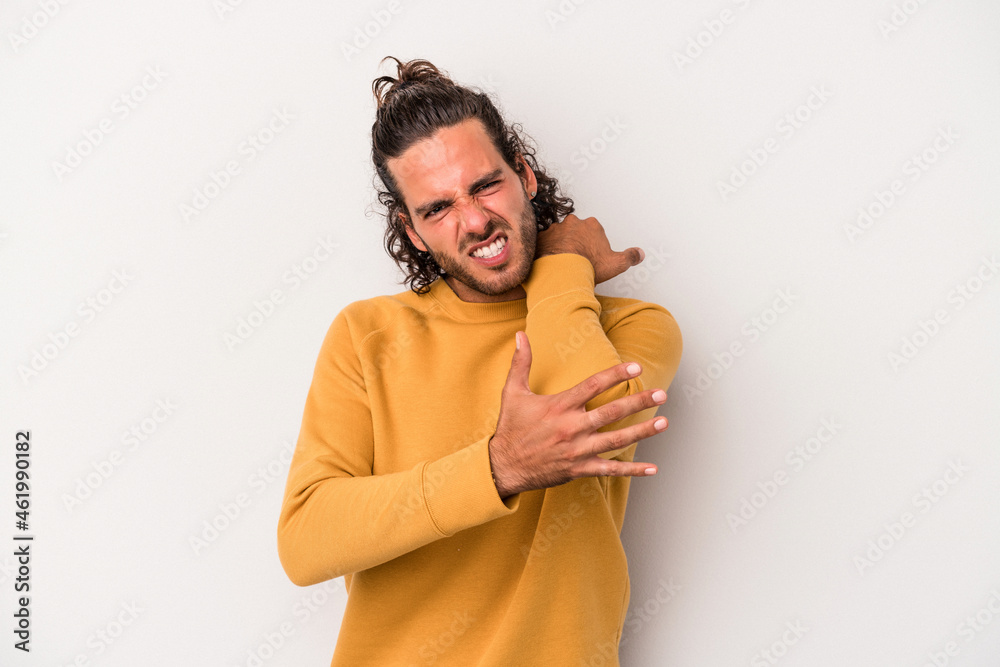 Young caucasian man isolated on gray background massaging elbow, suffering after a bad movement. Young caucasian man isolated on gray background massaging elbow, suffering after a bad movement.