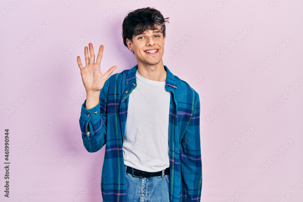 Handsome hipster young man wearing casual white t shirt and vintage shirt showing and pointing up with fingers number five while smiling confident and happy.