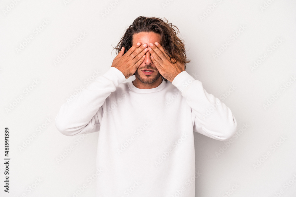 Young caucasian man isolated on gray background afraid covering eyes with hands. Young caucasian man isolated on gray background afraid covering eyes with hands.