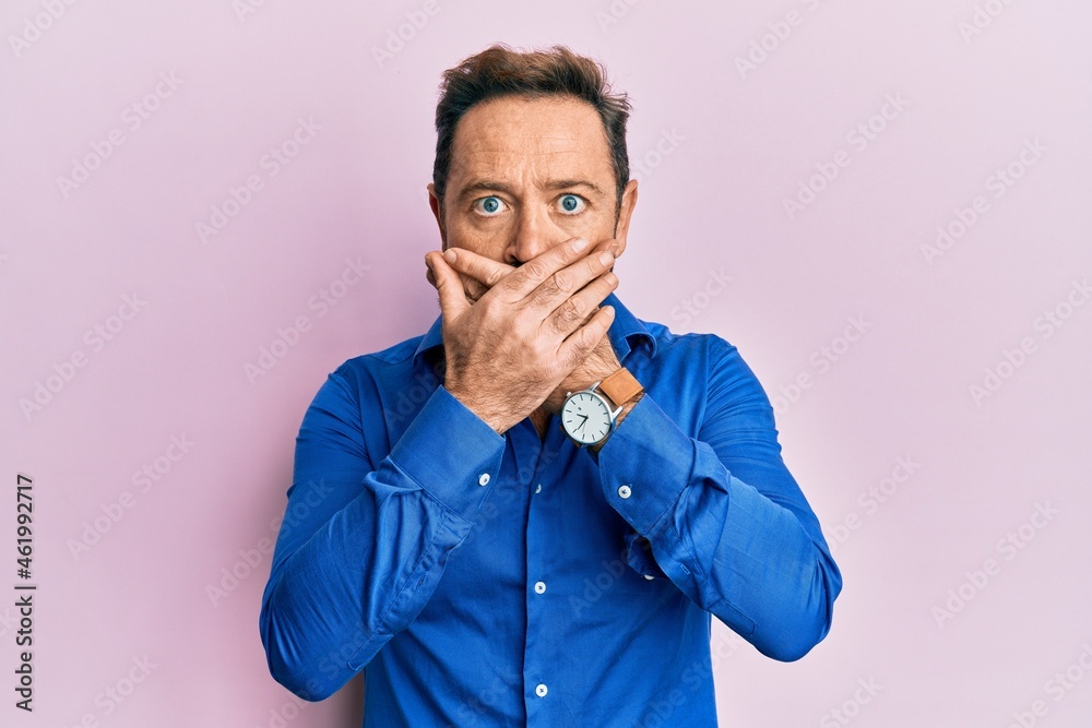 Middle age man wearing casual clothes shocked covering mouth with hands for mistake. secret concept. Middle age man wearing casual clothes shocked covering mouth with hands for mistake. secret concept.