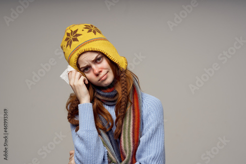 red-haired woman health problems temperature light background
