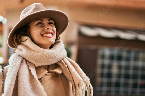 Young hispanic woman wearing elegant style standing at the city.